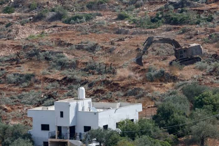 Israeli bulldozers cut Palestinian olive trees