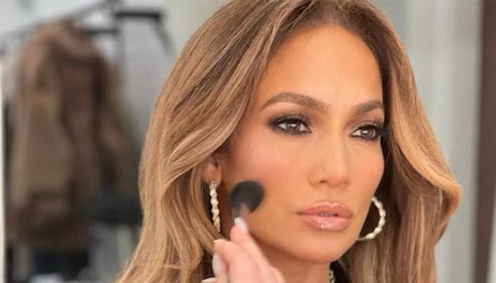 Jennifer Lopez's umbrella sparks debate at rain-filled fashion event