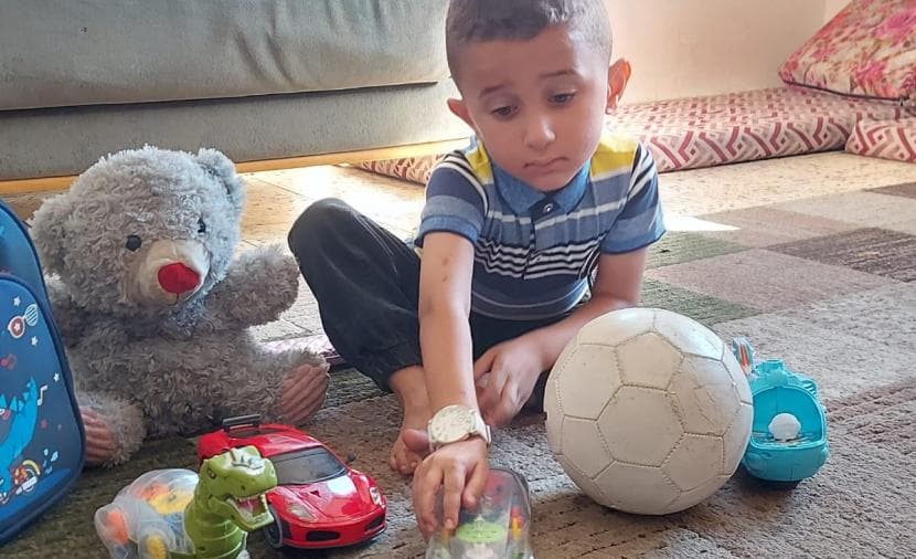 Mustafa Abed, the sole survivor, awaits treatment after carrying war shrapnel to save his hand