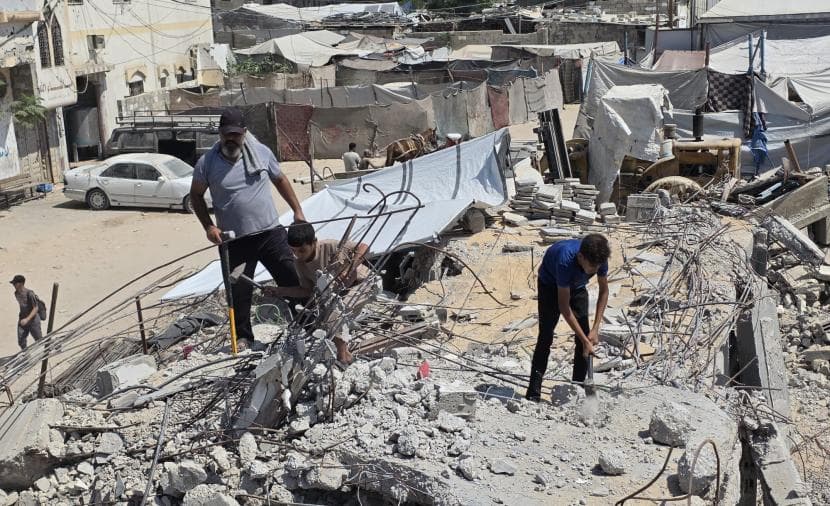 Family in Khan Yunis clears debris for shelter