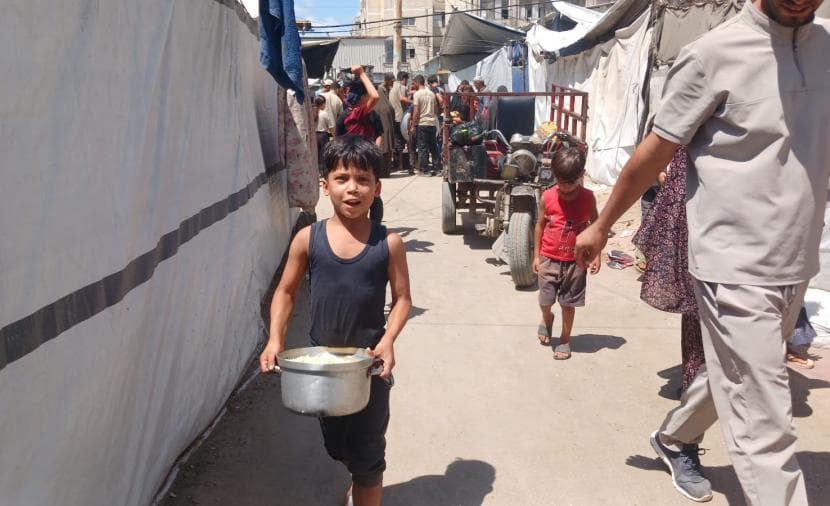 Children in camps face daily hardships from long water queues and food shortages