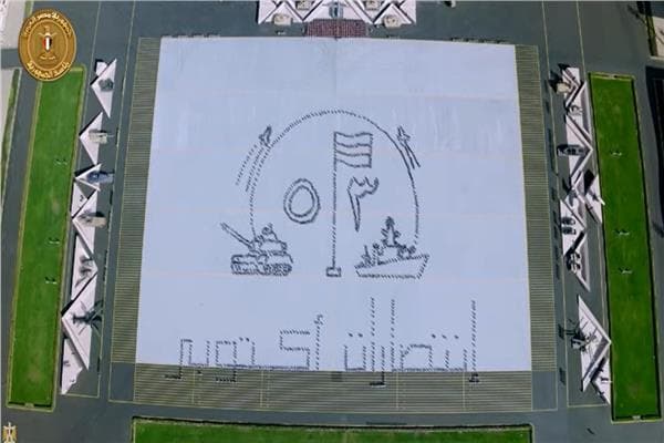 Academy graduates display "53 October Victories" slogan
