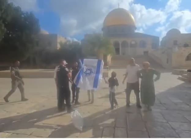Settler Displays Flag Near Dome of the Rock