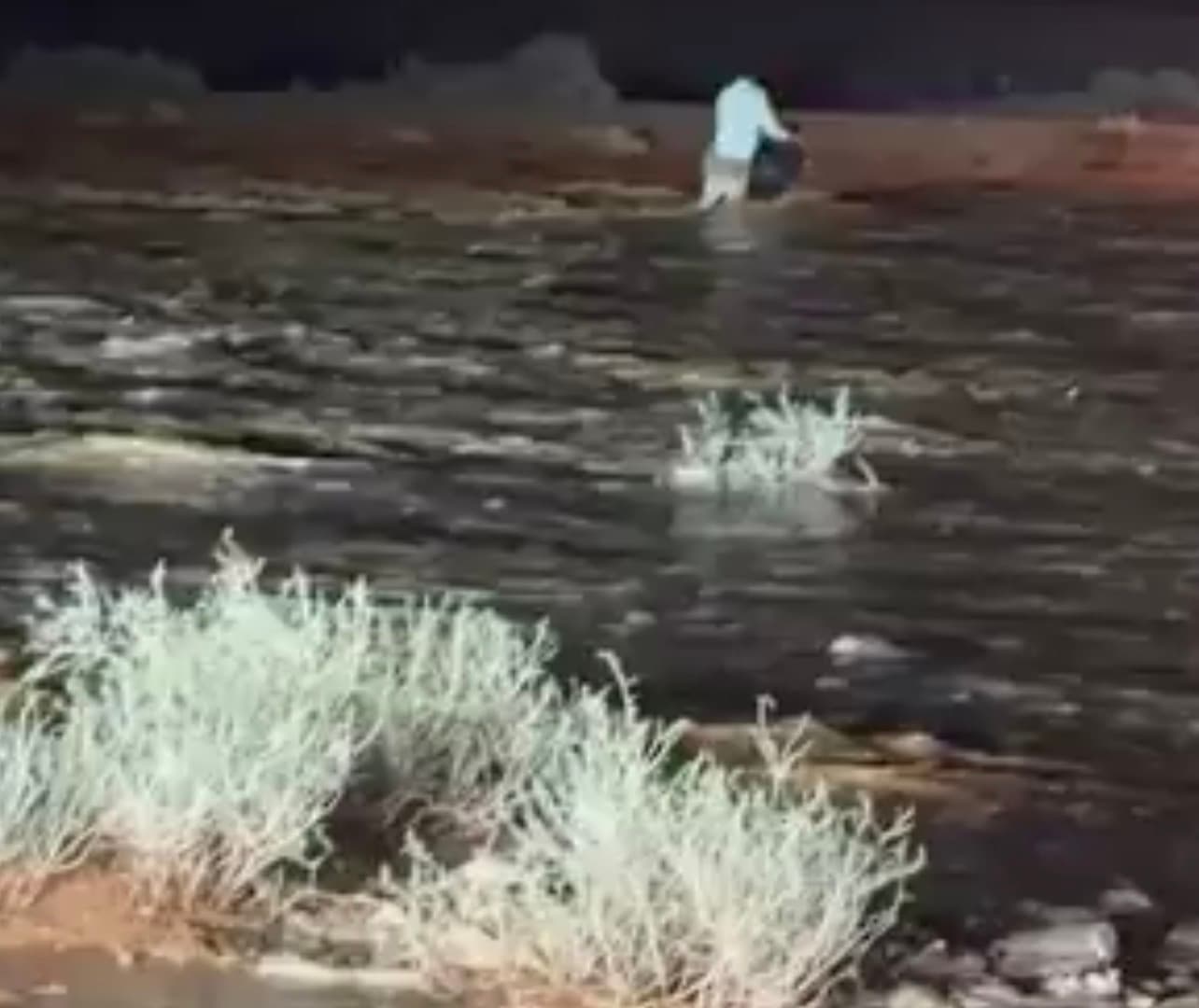 Rescue Operatives Search for Missing Person in Flood