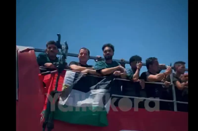 Palestinian and Egyptian flags displayed on national team bus amid cheering fans