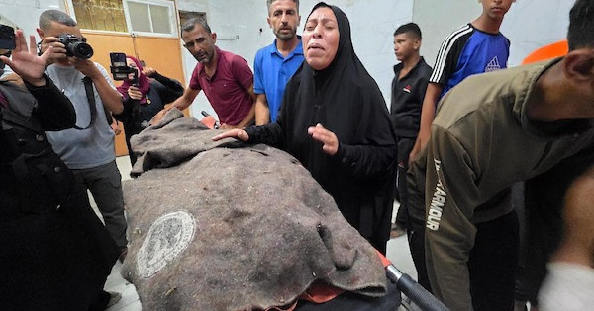 Palestinians move bodies and injured after Gaza airstrike