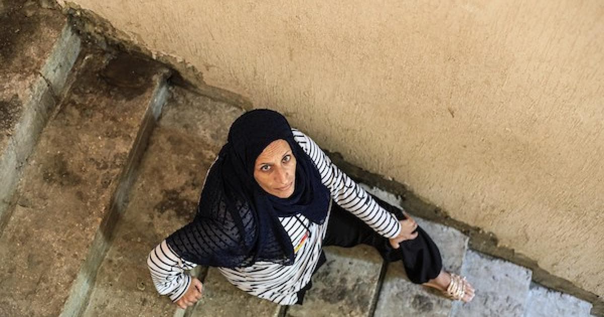 Injured Palestinian woman persists amid Gaza rubble