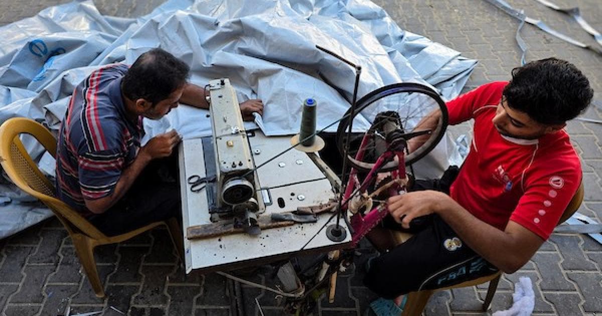 Gaza tailor repairs tents for winter