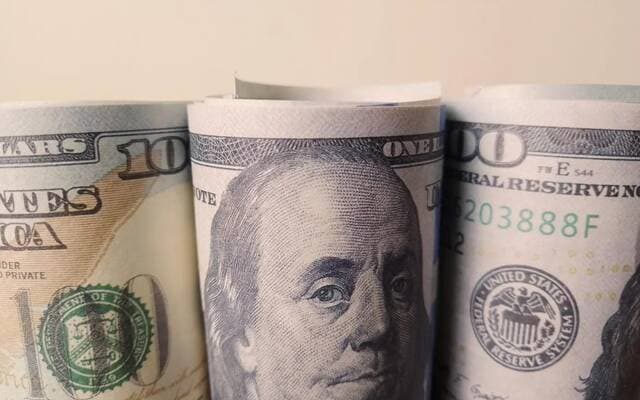 The dollar remains steady near its highest level ahead of Federal Reserve minutes release