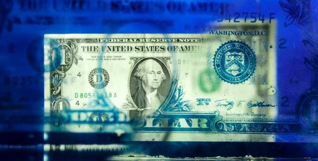 Dollar falls for second month amid bond buyback