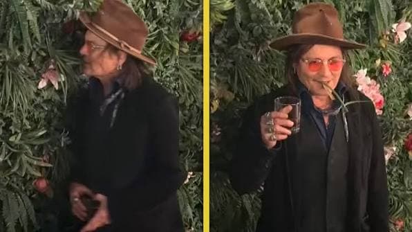 Depp exhibits unusual behavior before cameras