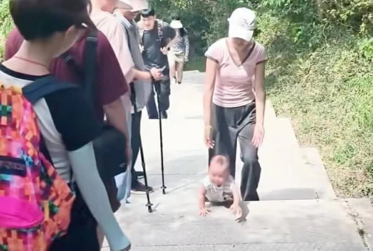 Baby climbs mountain stairs