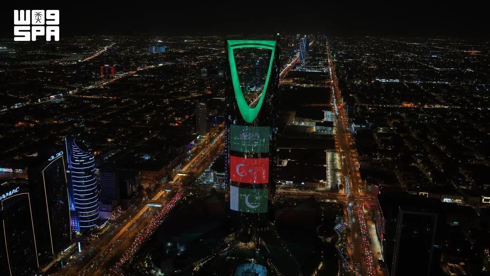 City landmarks display flags of the Kingdom, Turkey, and Pakistan