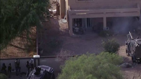 Unidentified man barricades in California house