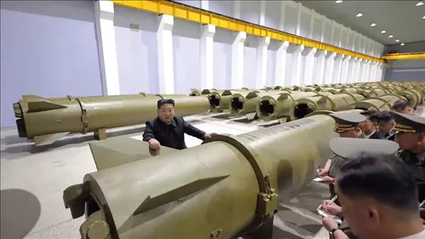 Kim warns of a heavy blow on testing new weapon