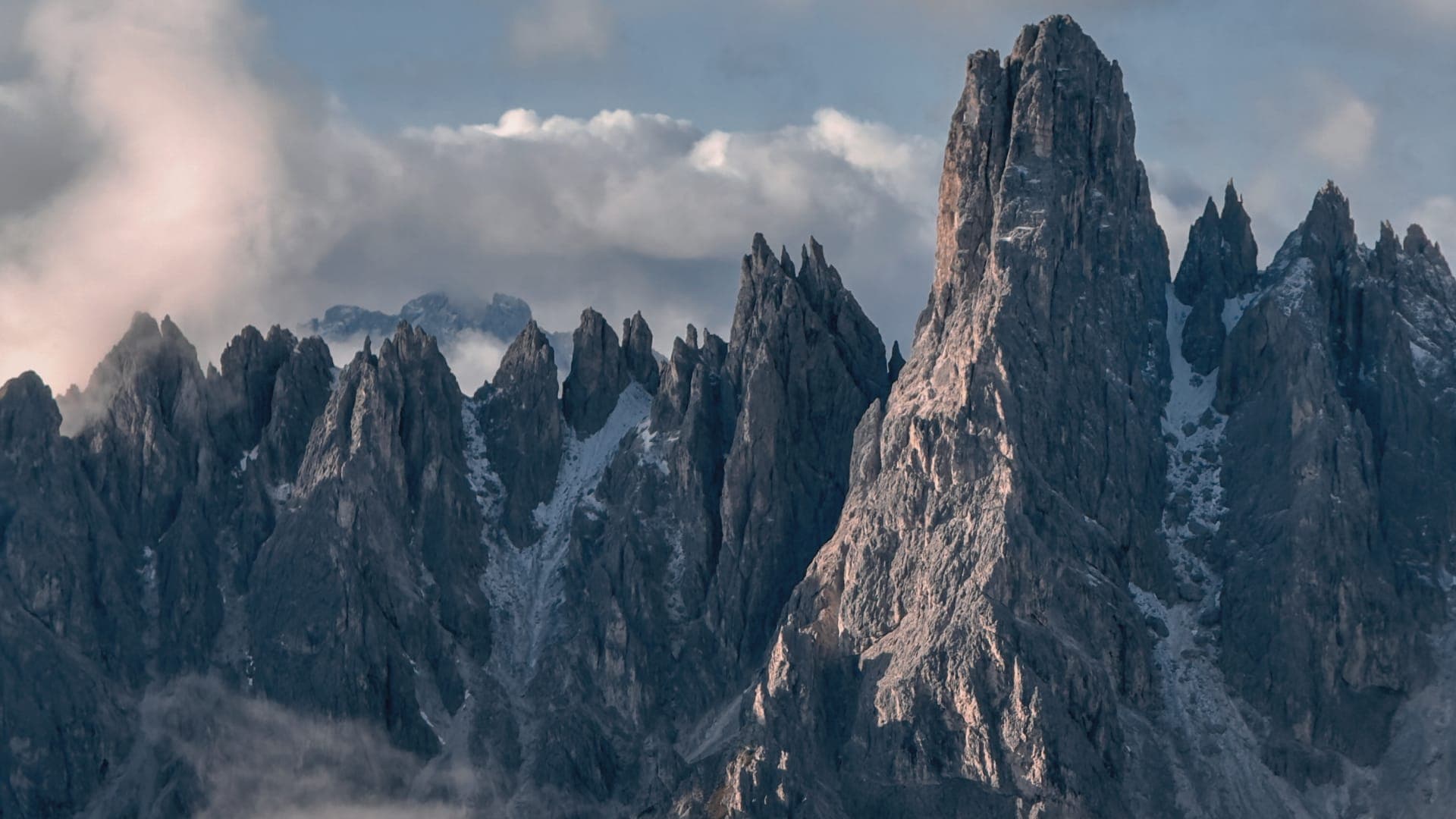 Three peaks hidden in Dolomites rocky frame